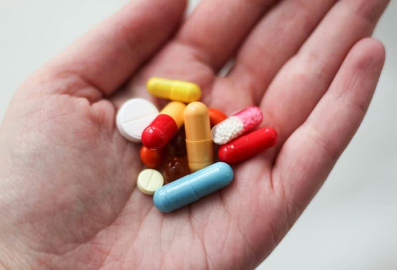 Hand hold a selection of pills, pills are the most common treatments fro fibromyalgia, but there are other options